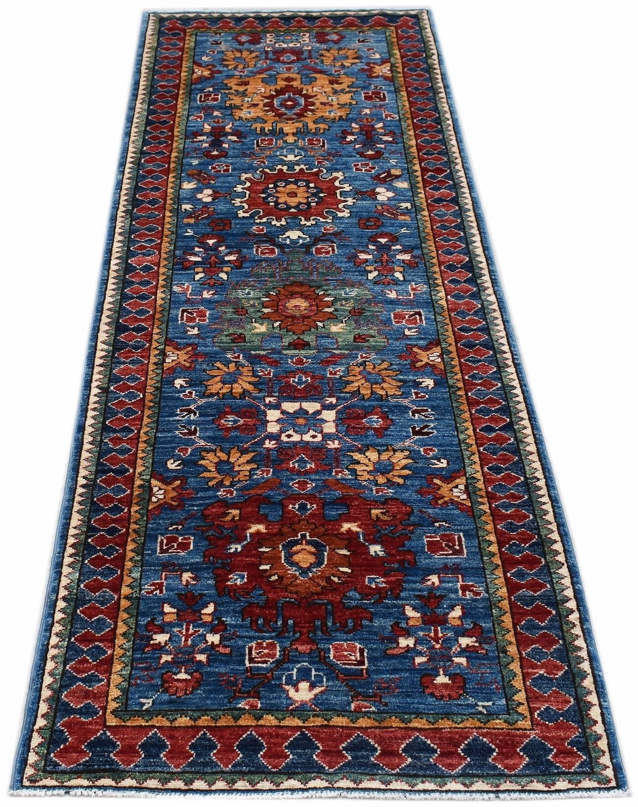 A handmade Afghan Chobi runner rug featuring traditional floral patterns in blue, red, and gold.