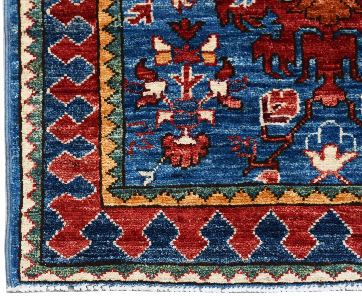 A hand-knotted Afghan Chobi runner featuring a blue field with red and cream floral motifs.