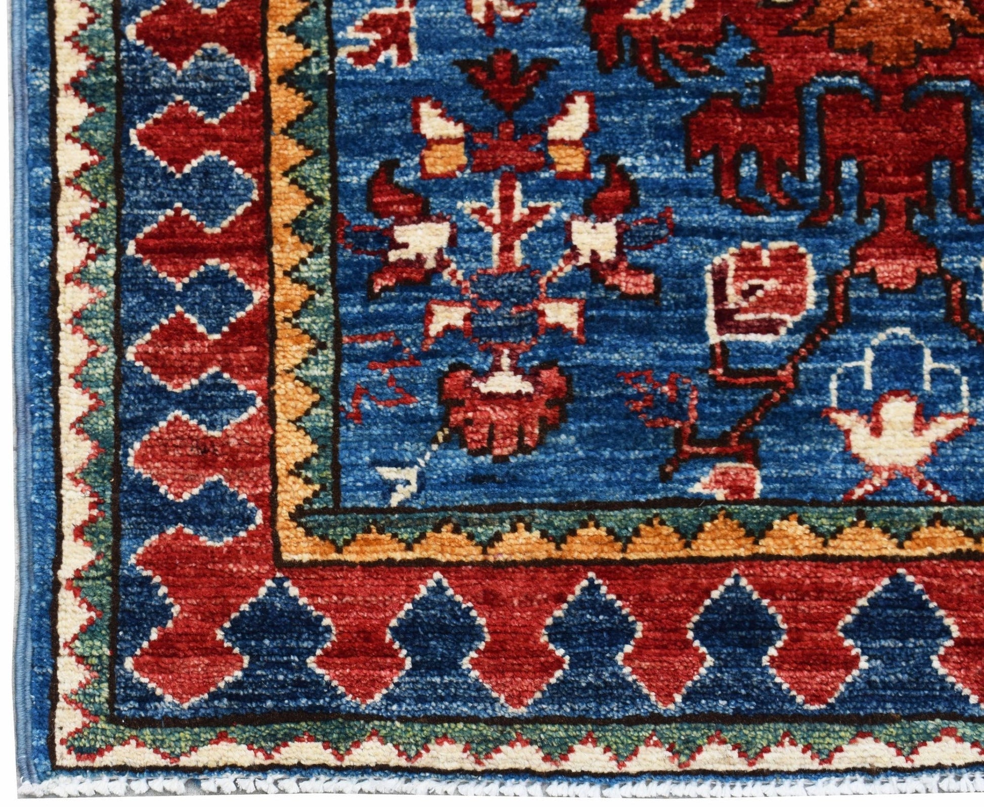 A hand-knotted Afghan Chobi runner featuring a blue field with red and cream floral motifs.