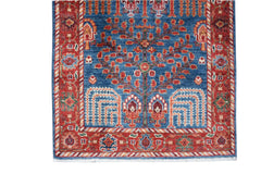 Handwoven Afghan Chobi runner featuring a tree of life motif in red and blue wool.