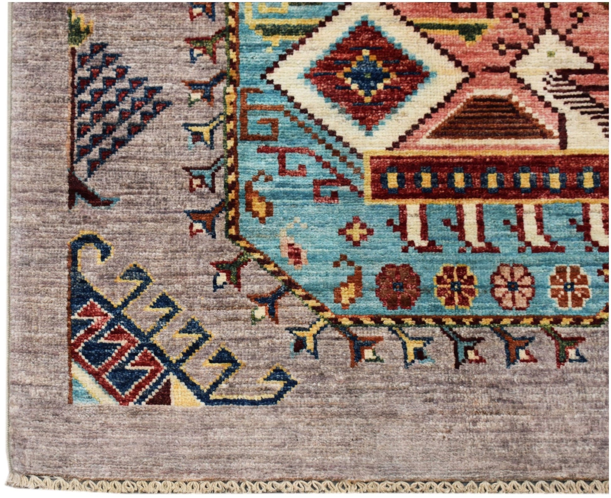 A hand-knotted Afghan Chobi runner featuring a geometric pattern in blue, red, and earthy tones.