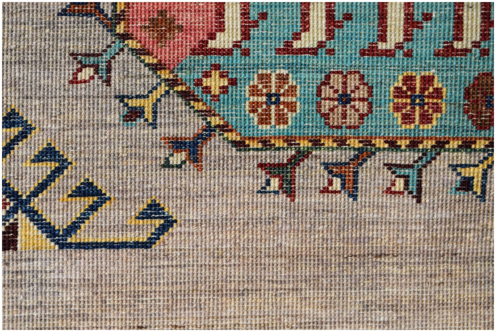 A close-up of a hand-knotted Afghan Chobi runner featuring intricate floral and geometric patterns.