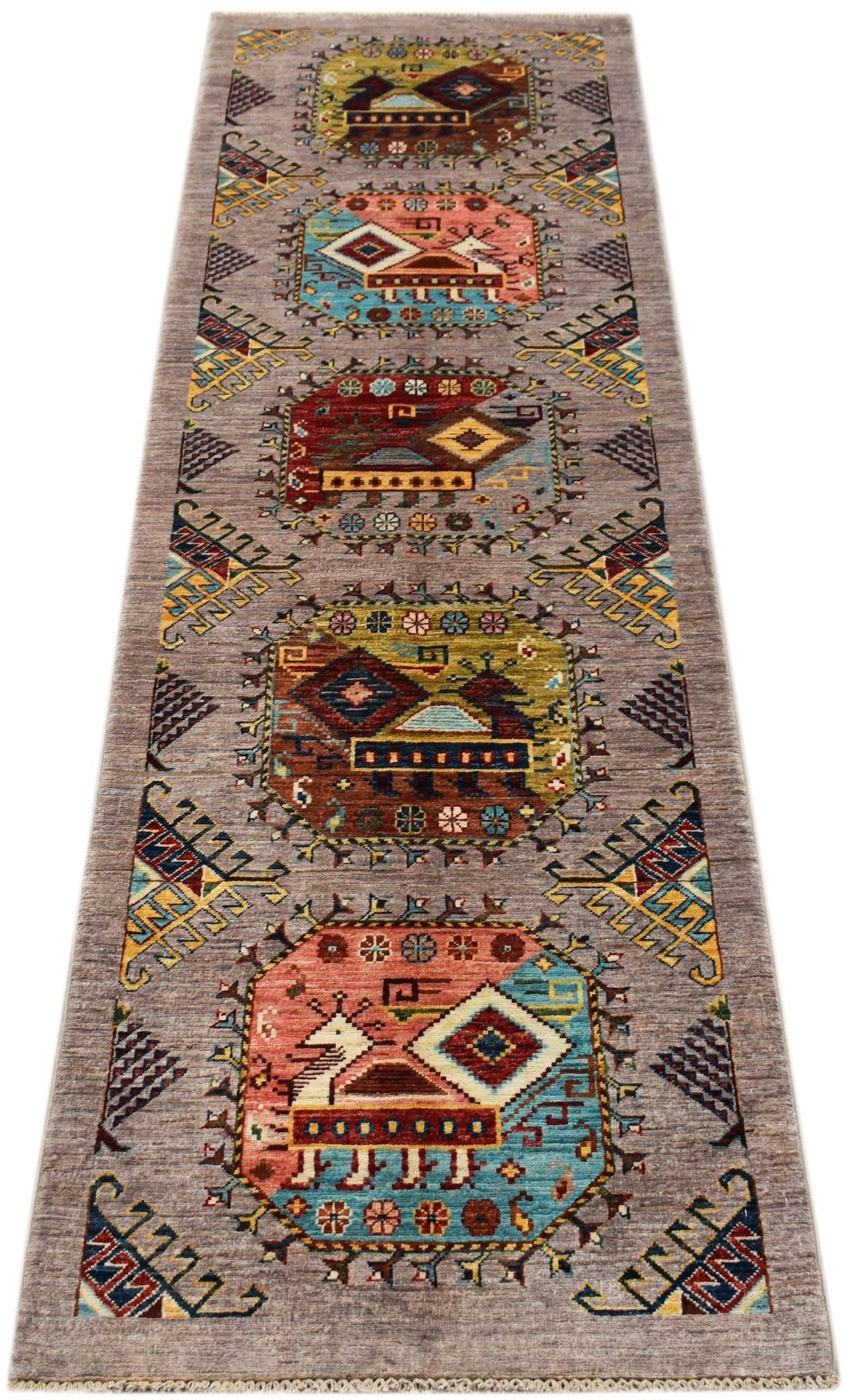 An Afghan Chobi runner rug featuring geometric medallions and animal motifs on a grey background.