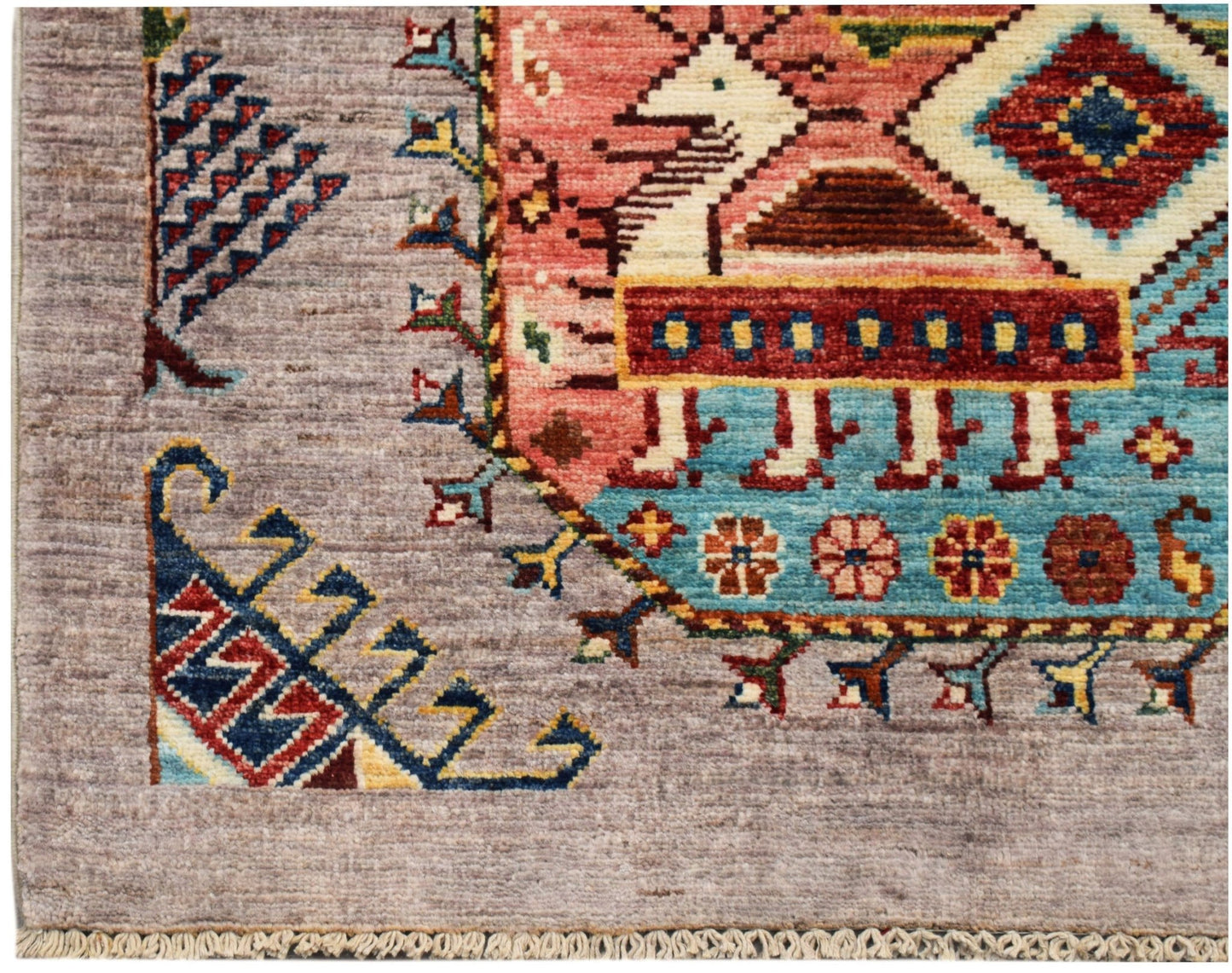 A hand-knotted Afghan Chobi runner featuring a geometric animal motif on a light grey background.