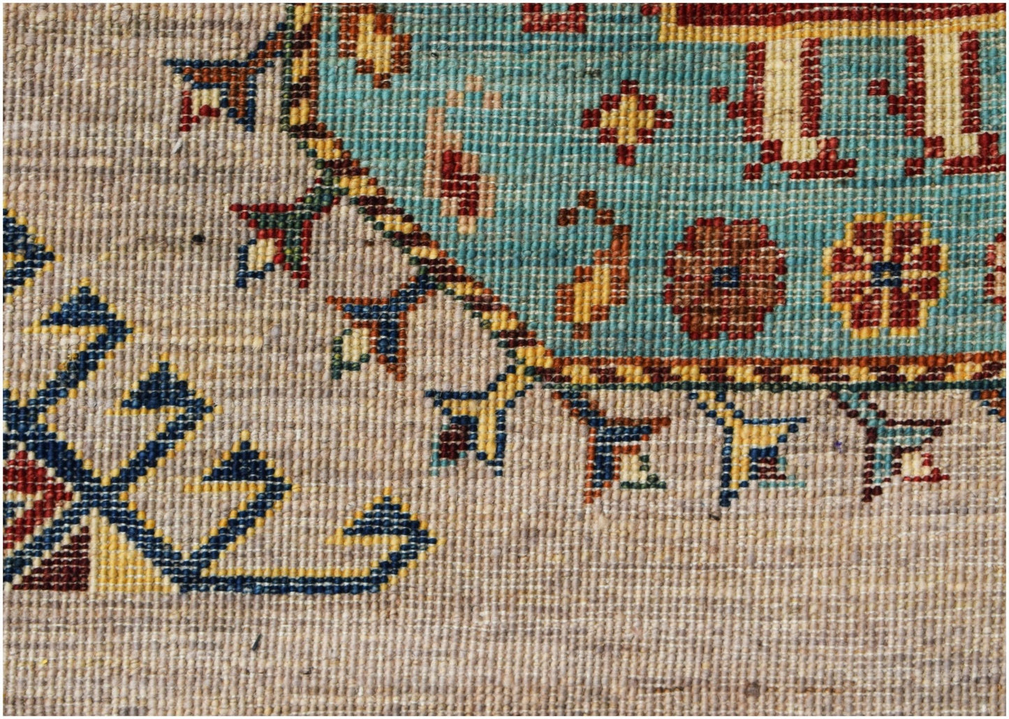 A close-up of a hand-knotted Afghan Chobi runner featuring intricate floral and geometric patterns.