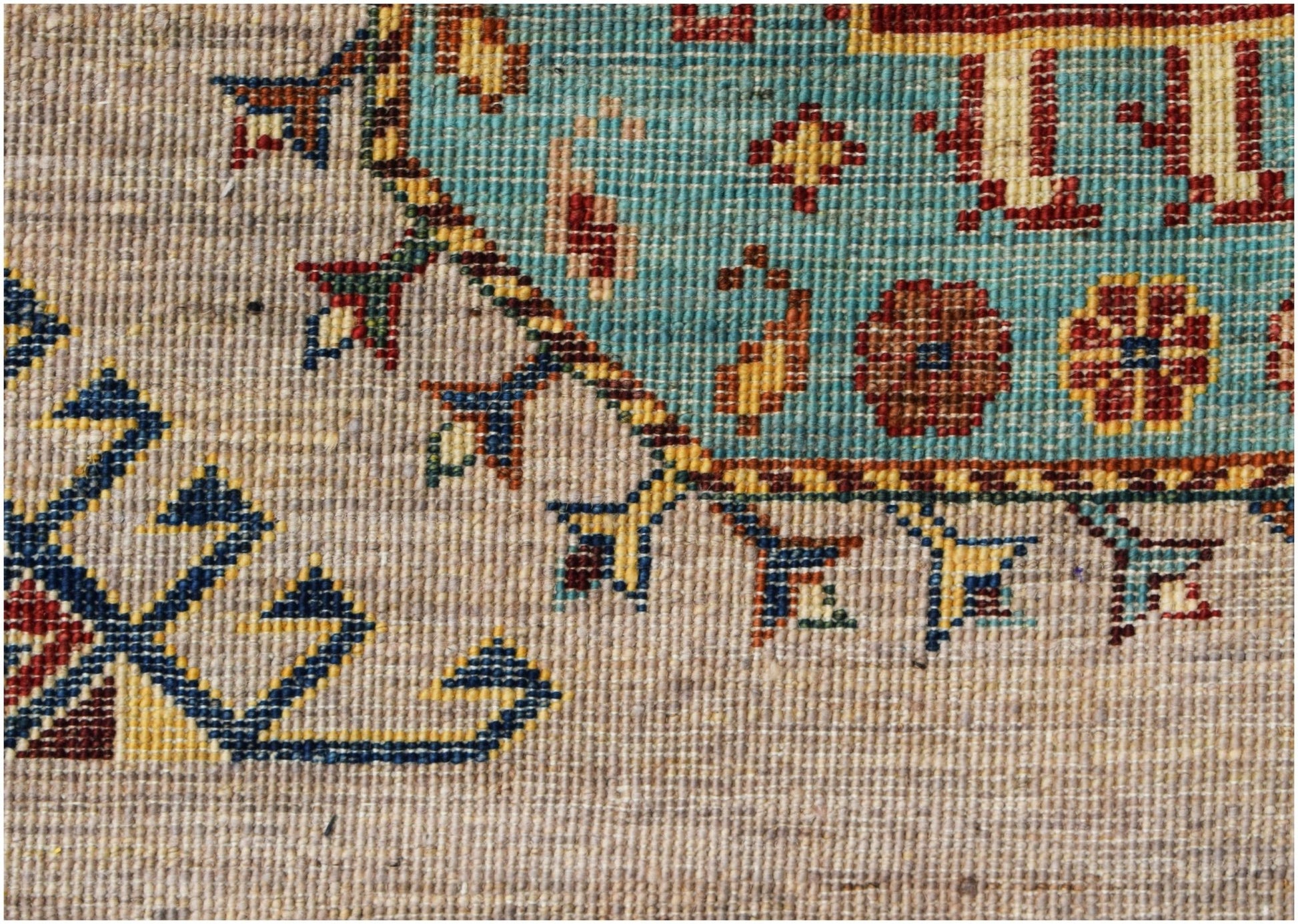 A close-up of a hand-knotted Afghan Chobi runner featuring intricate floral and geometric patterns.