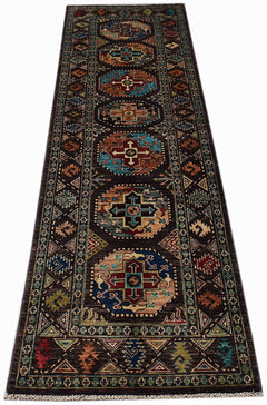 A handmade Afghan Chobi runner rug featuring geometric medallions on a dark brown background.