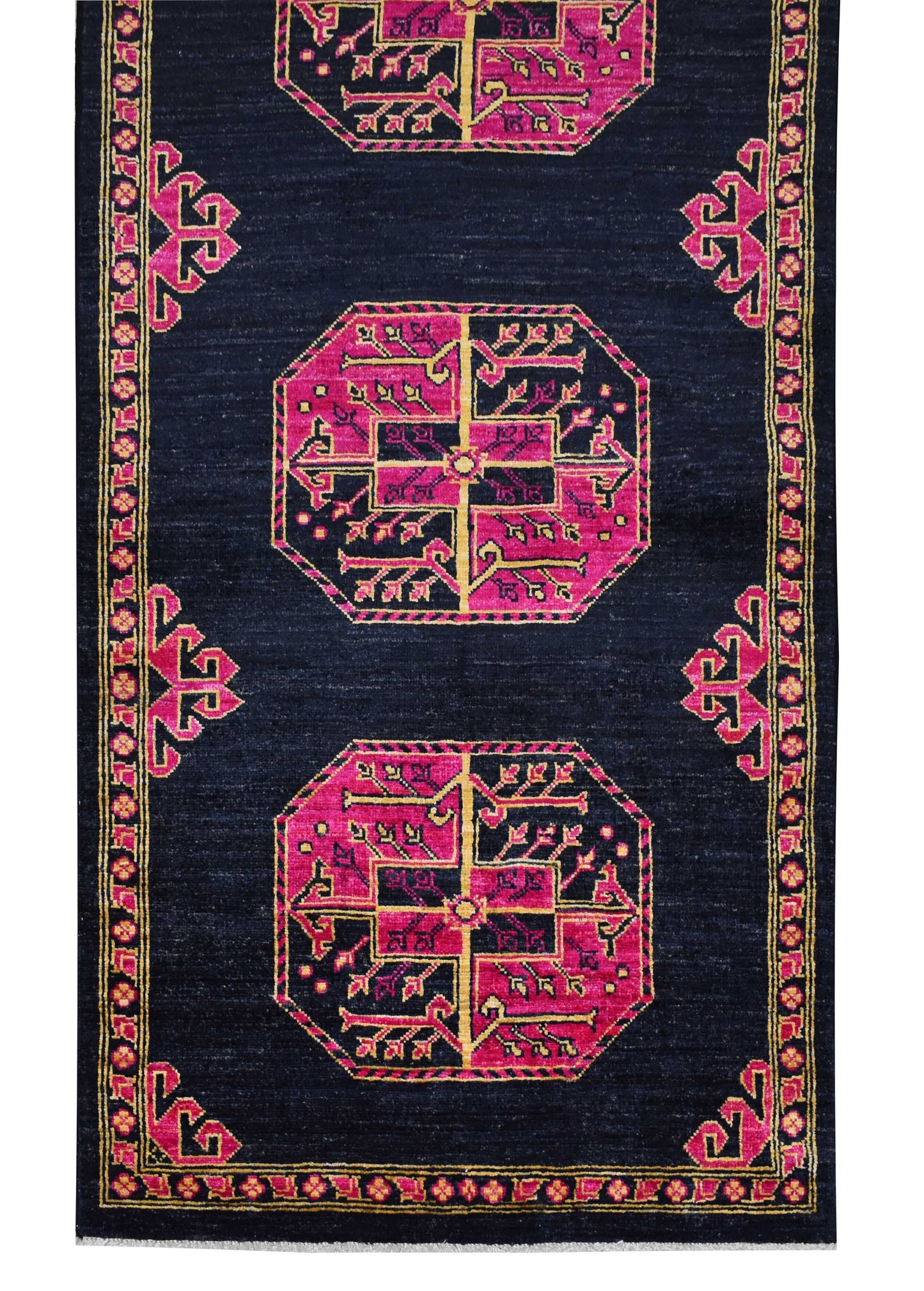 An Afghan Chobi runner rug featuring pink geometric medallions on a dark navy blue background.