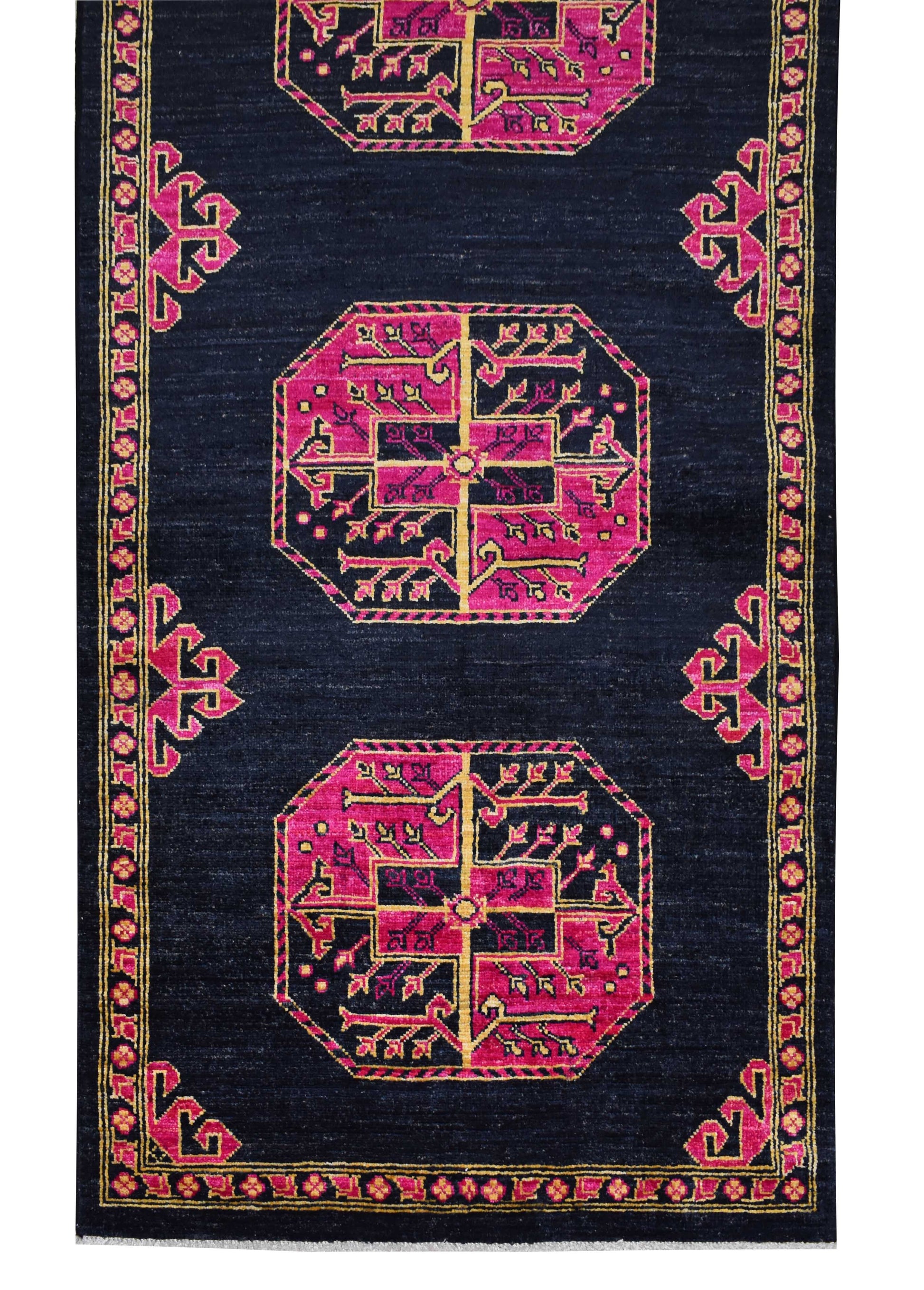 An Afghan Chobi runner rug featuring pink geometric medallions on a dark navy blue background.