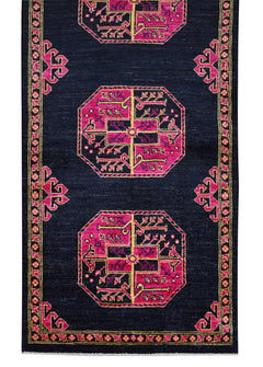An Afghan Chobi runner rug featuring pink geometric medallions on a dark navy blue background.
