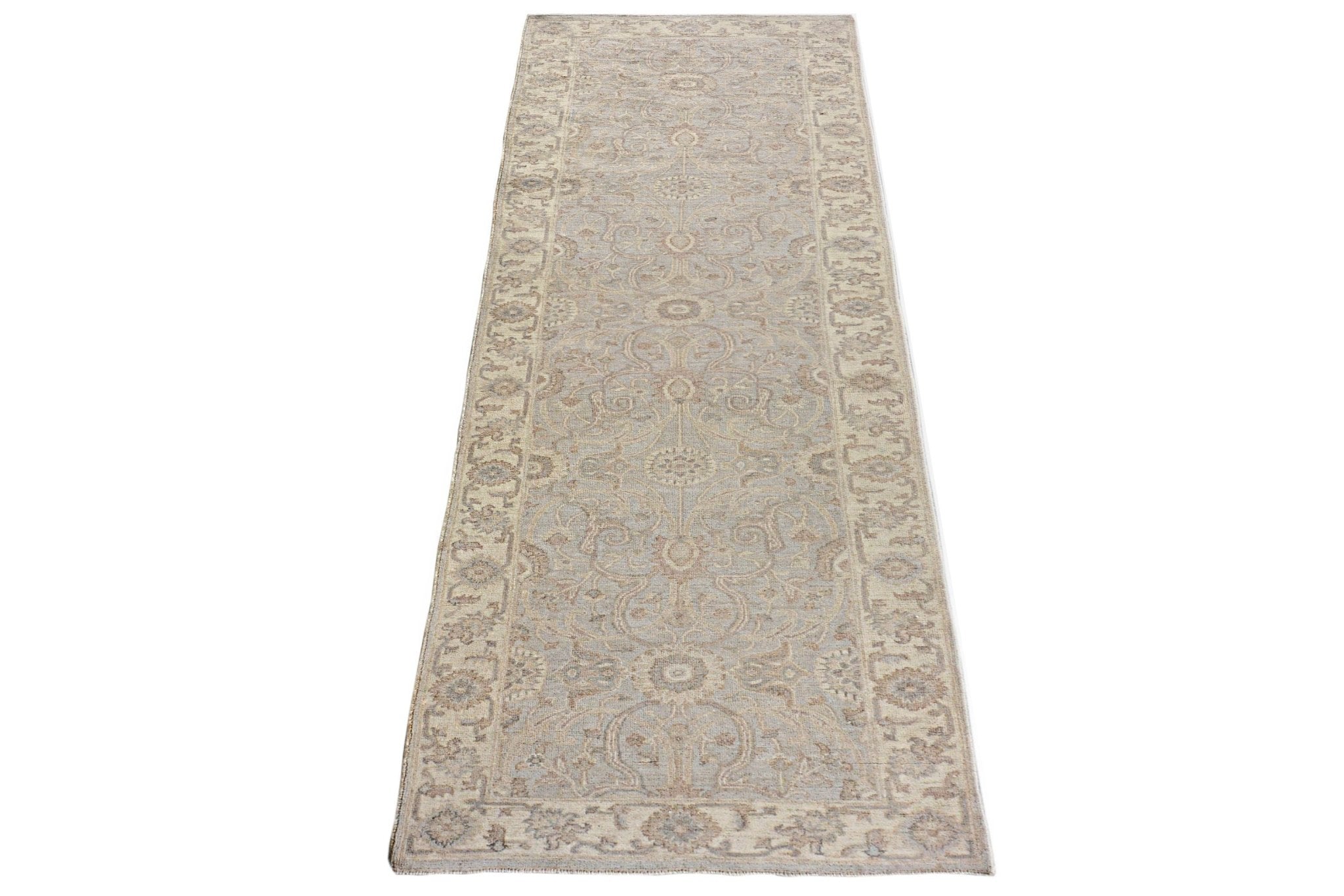An Afghan Chobi runner rug featuring a traditional floral pattern in soft beige and blue tones.