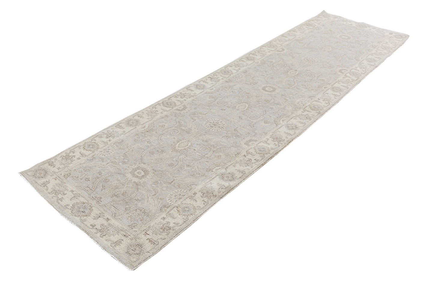A handmade Afghan Chobi runner rug featuring a traditional floral pattern in neutral beige tones.