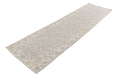 A handmade Afghan Chobi runner rug featuring a traditional floral pattern in neutral beige tones.