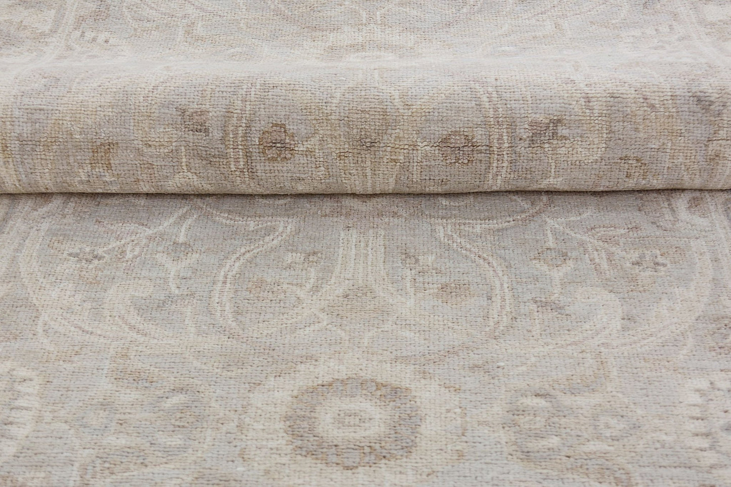 A handmade Afghan Chobi runner featuring a traditional beige and brown floral pattern.