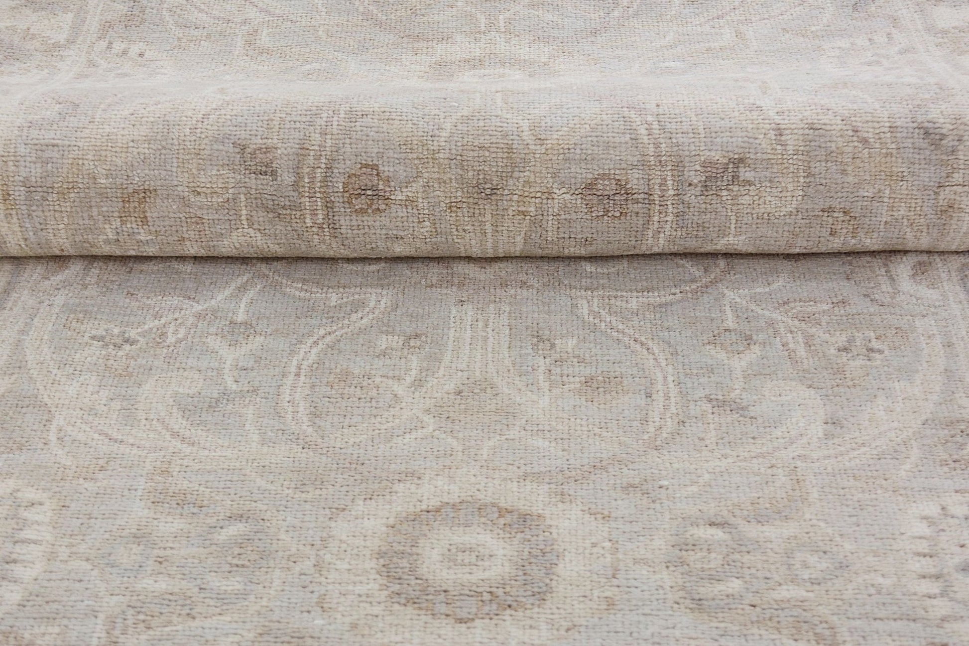 A handmade Afghan Chobi runner featuring a traditional beige and brown floral pattern.