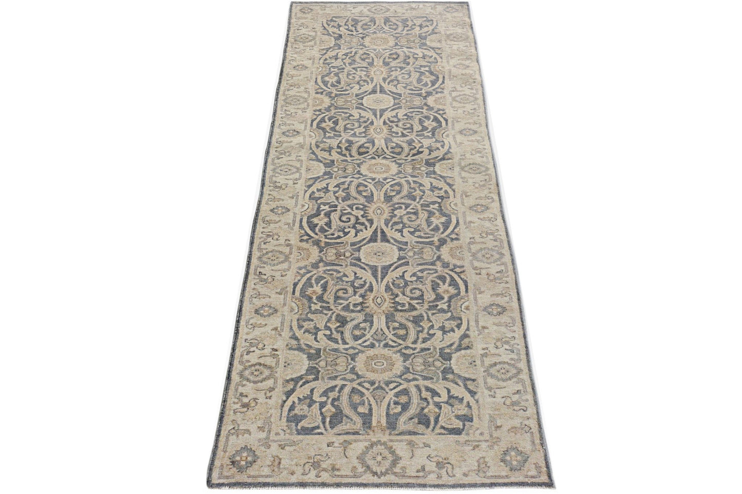 An Afghan Chobi runner rug featuring a traditional blue and beige floral pattern.