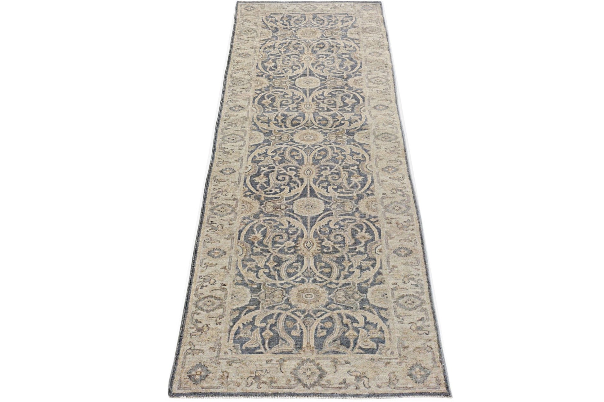 An Afghan Chobi runner rug featuring a traditional blue and beige floral pattern.