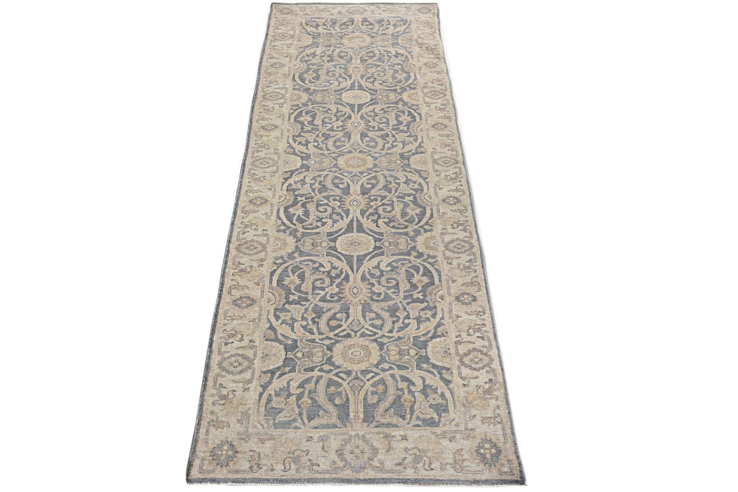A handmade Afghan Chobi runner rug featuring a traditional floral pattern in blue and beige tones.