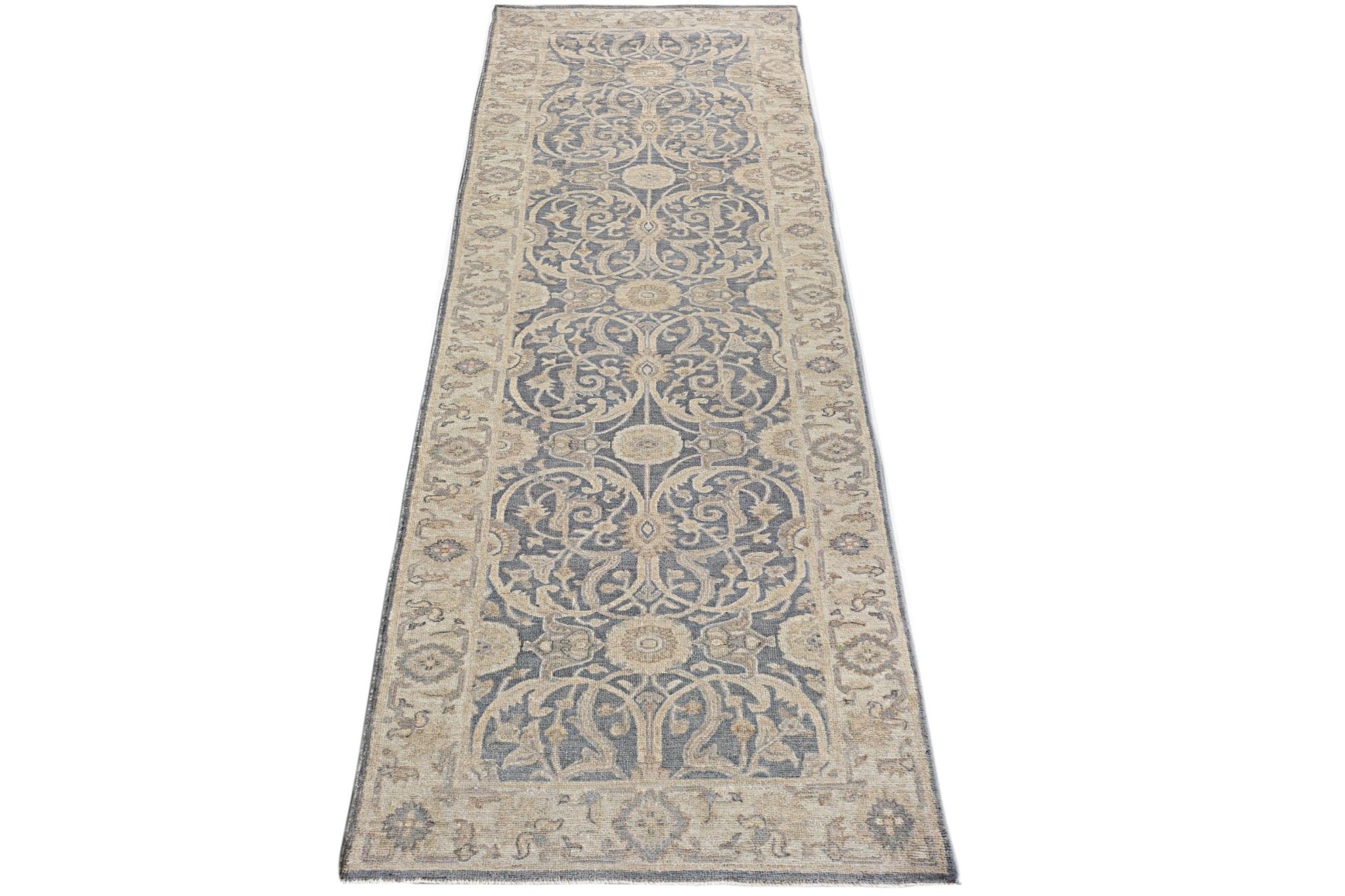 A handmade Afghan Chobi runner rug featuring a traditional floral pattern in blue and beige tones.