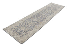 An Afghan Chobi runner rug featuring a traditional blue and beige floral pattern.