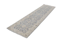 An Afghan Chobi runner rug featuring a traditional blue and beige floral pattern.