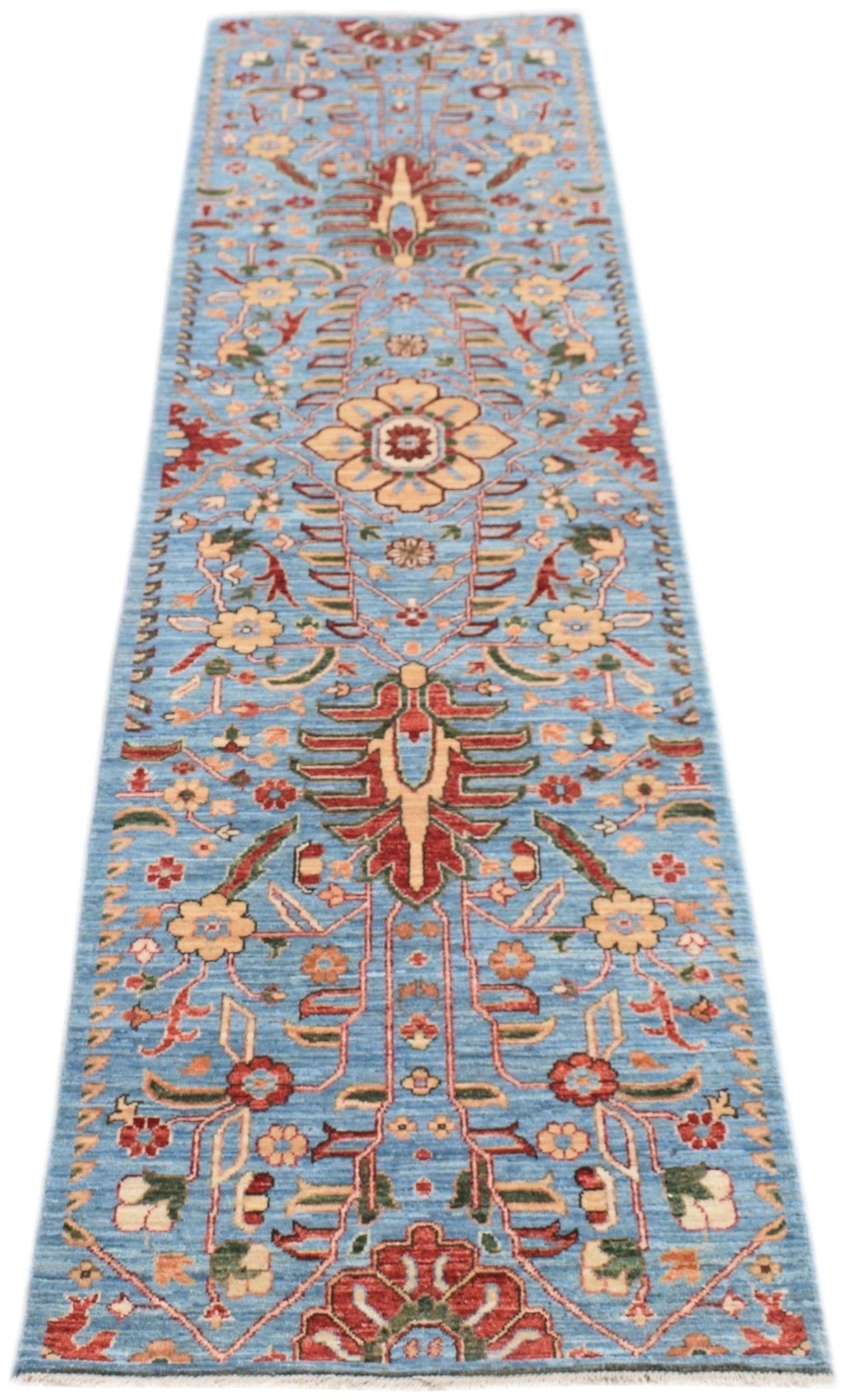 An Afghan Chobi runner rug featuring a traditional floral pattern in red and beige on a blue field.