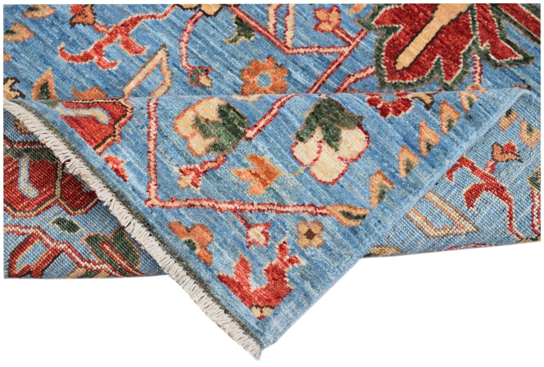 A hand-knotted Afghan Chobi runner featuring a traditional floral pattern in blue and red tones.