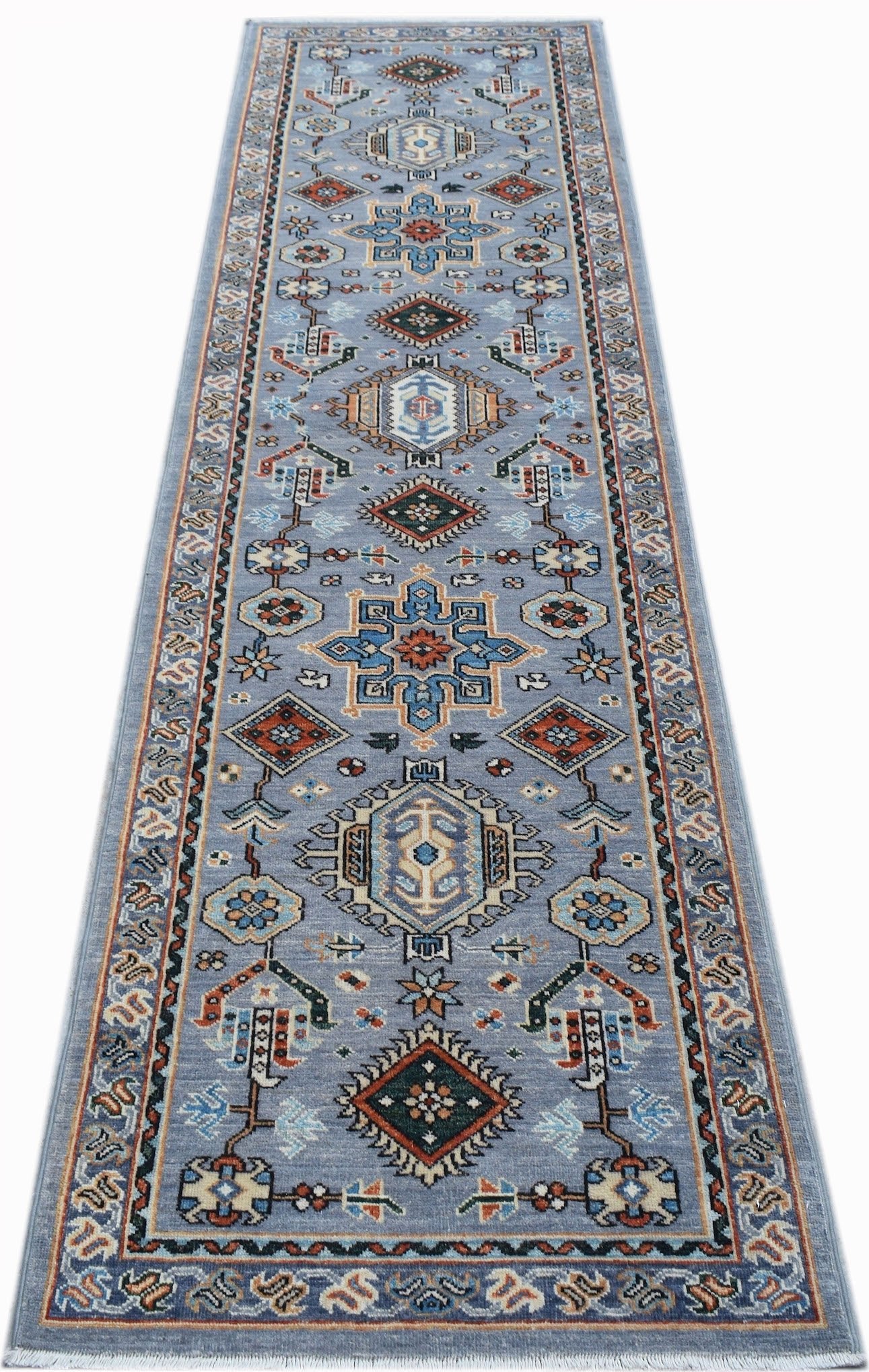 A hand-knotted Afghan Chobi runner rug featuring traditional geometric patterns in blue tones.