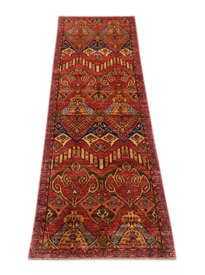 A handmade Afghan Chobi runner rug featuring traditional geometric patterns in warm earthy tones.