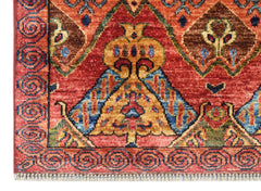 A handmade Afghan Chobi runner featuring traditional geometric patterns in red, blue, and gold.