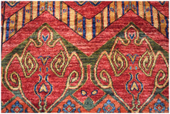 A handmade Afghan Chobi runner featuring intricate traditional patterns in red, green, and gold.