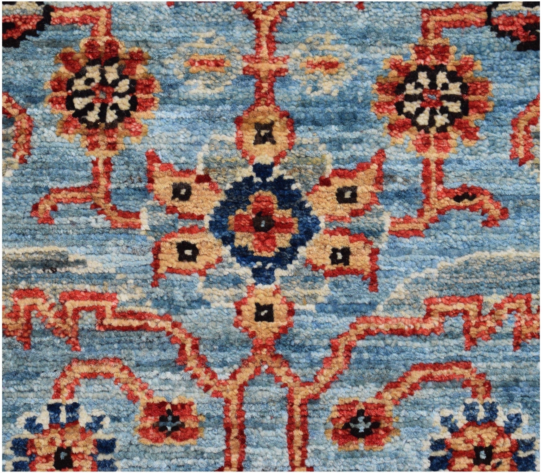 A handmade Afghan Chobi runner featuring a traditional floral pattern in red, blue, and tan.