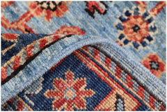 A folded Afghan Chobi runner featuring a traditional floral pattern in blue, red, and beige tones.