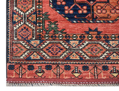 A handmade Afghan Chobi runner featuring traditional geometric patterns in red, blue, and tan.