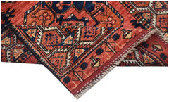 A handwoven Afghan Chobi runner featuring traditional geometric patterns in red and blue tones.