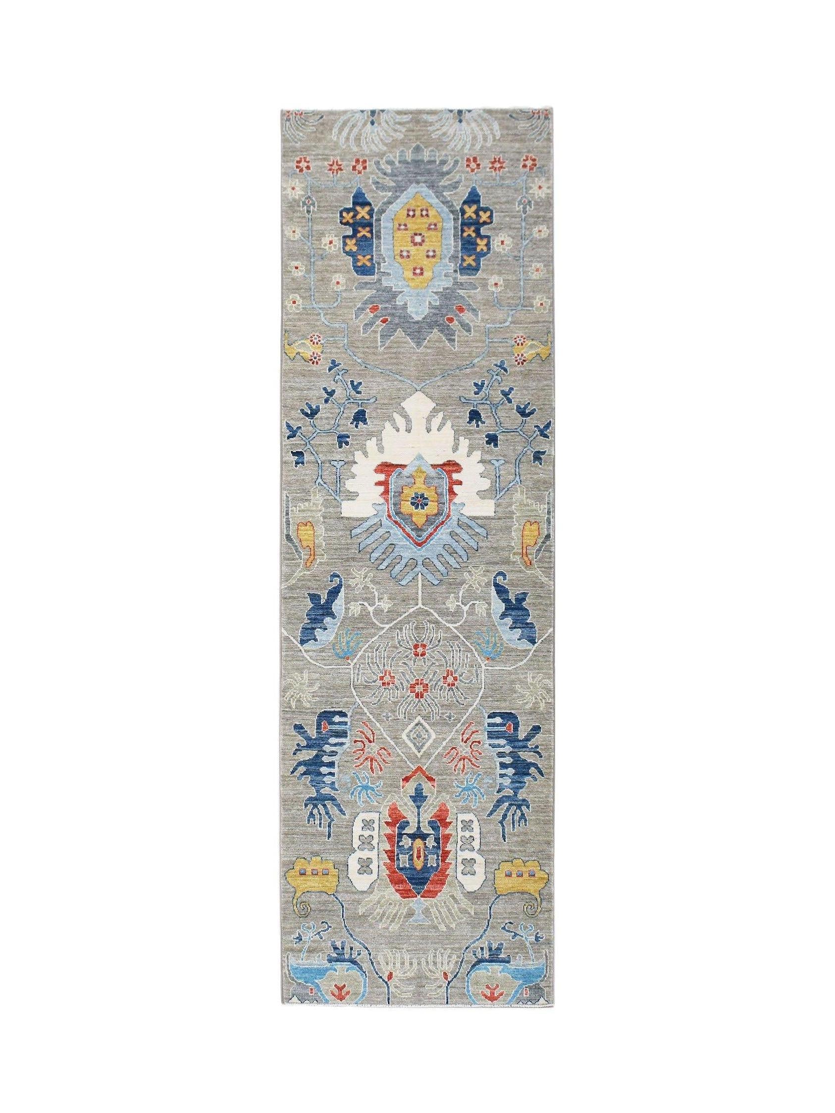 An Afghan Chobi runner rug featuring a traditional floral pattern in blue, red, and yellow tones.