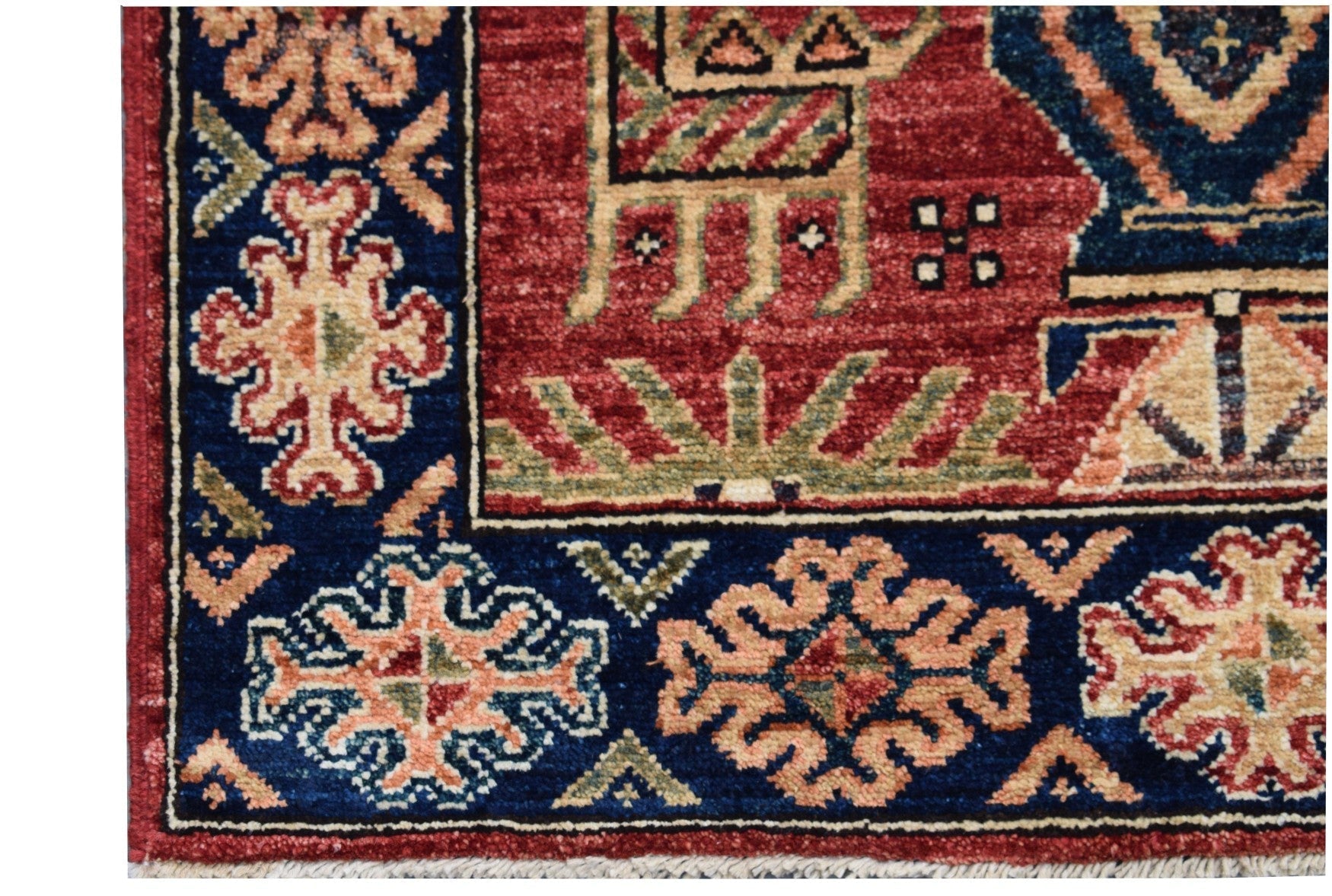Handmade Afghan Chobi runner featuring traditional geometric patterns in red and blue tones.