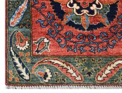 A handmade Afghan Chobi runner featuring a traditional floral pattern in red, blue, and green.