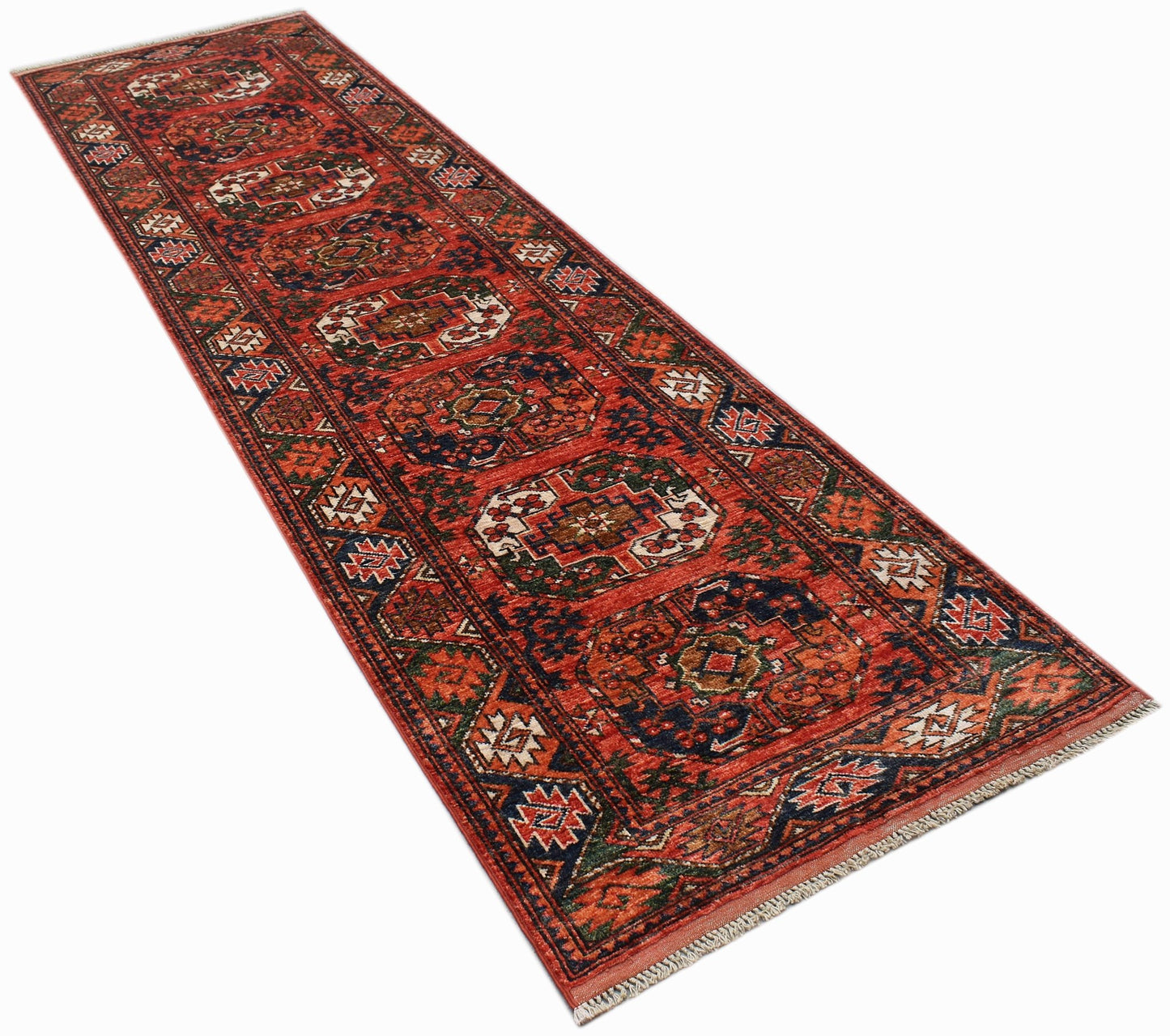 A handmade Afghan Chobi runner rug featuring a traditional geometric pattern in red and blue tones.