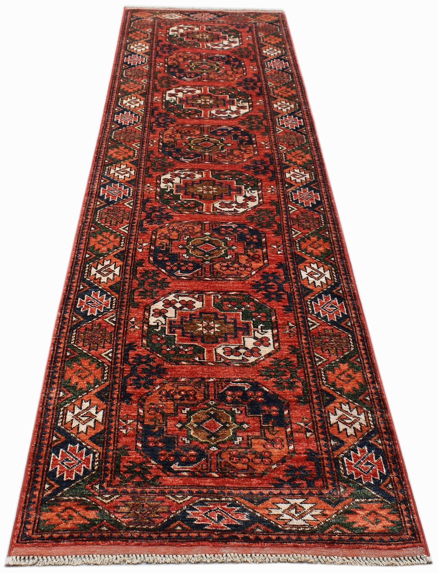 A handmade Afghan Chobi runner rug featuring traditional geometric patterns in red and blue tones.
