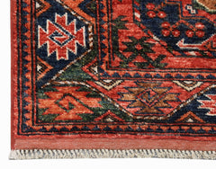 A corner view of a handwoven Afghan Chobi runner featuring traditional geometric patterns in red.