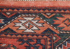 A close-up of a handwoven Afghan Chobi runner featuring intricate geometric patterns in wool.