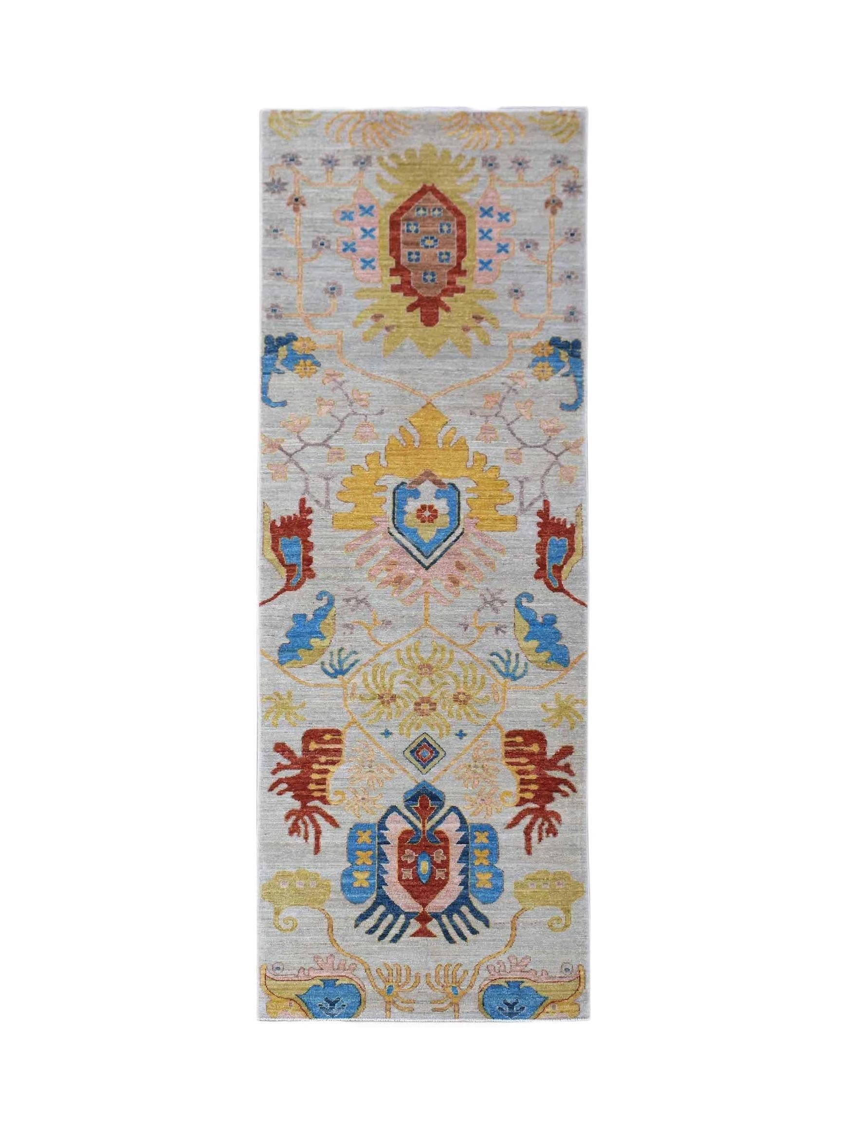 Handwoven Afghan Chobi runner featuring traditional floral motifs in vibrant colors on a grey base.