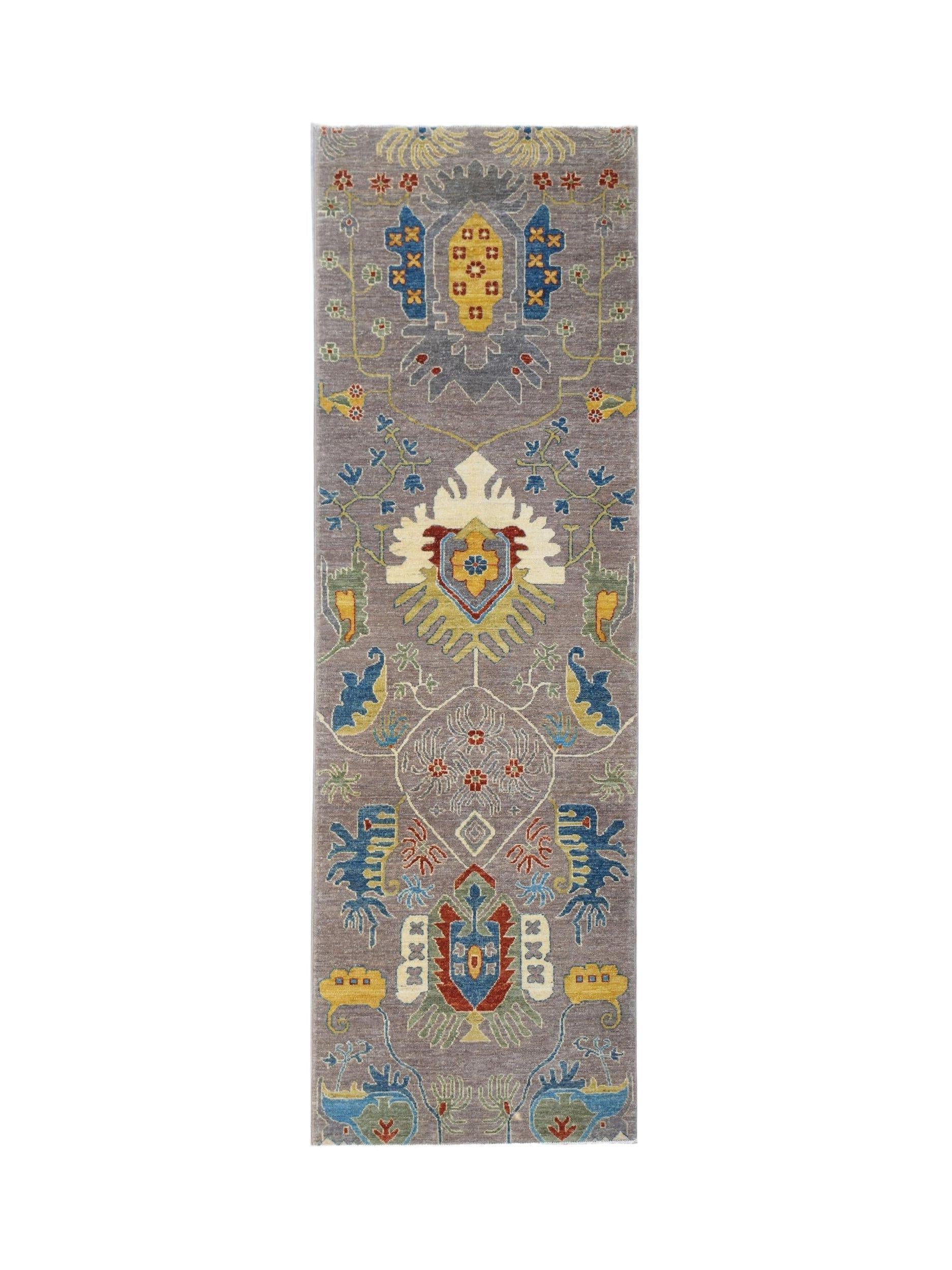 A handwoven Afghan Chobi runner featuring traditional floral motifs in muted earth tones.