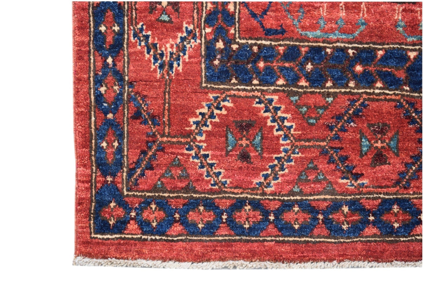 A handmade Afghan Chobi runner featuring a traditional red and blue geometric tribal pattern.