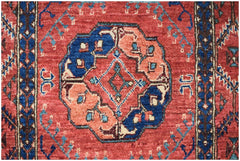 An Afghan Chobi runner featuring a central geometric medallion in blue and peach on a red field.