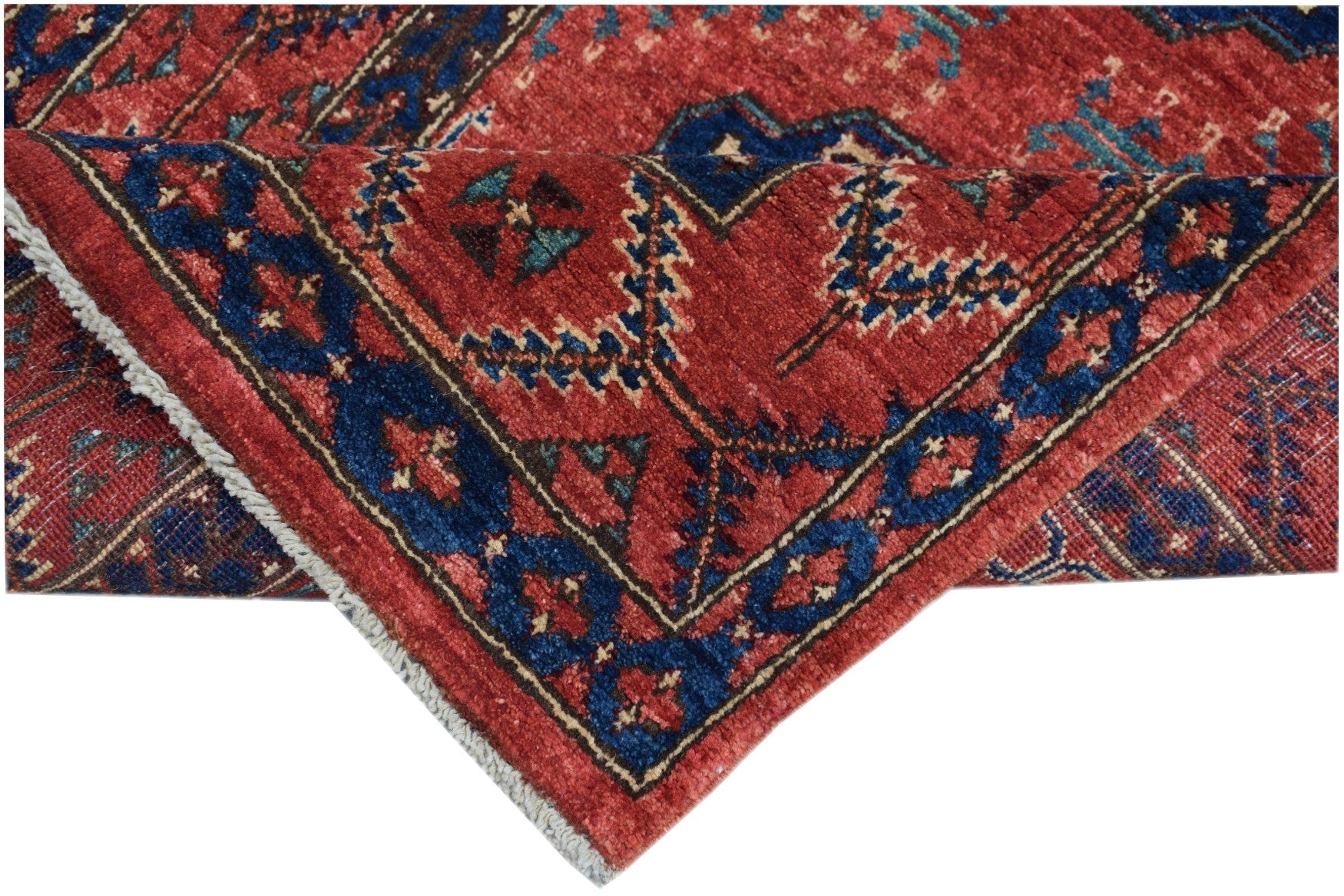 A handmade Afghan Chobi runner featuring a traditional red and blue geometric pattern.
