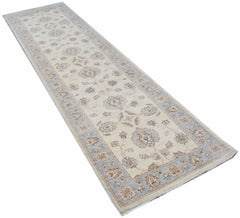 A handmade Afghan Chobi runner rug featuring a traditional floral pattern in soft earth tones.