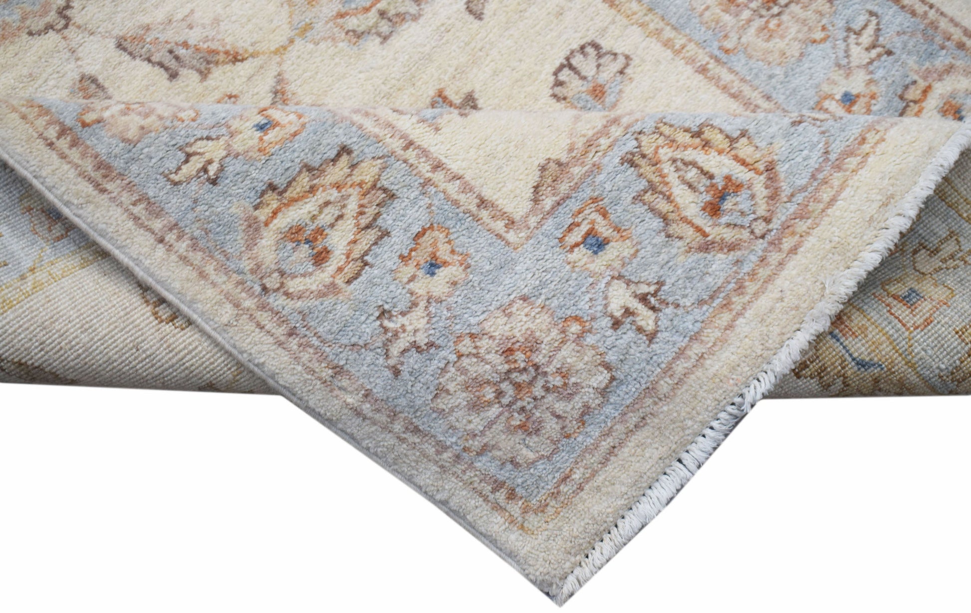 A corner view of a handwoven Afghan Chobi runner featuring traditional floral patterns in soft tones.