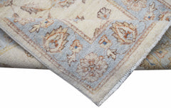 A corner view of a handwoven Afghan Chobi runner featuring traditional floral patterns in soft tones.